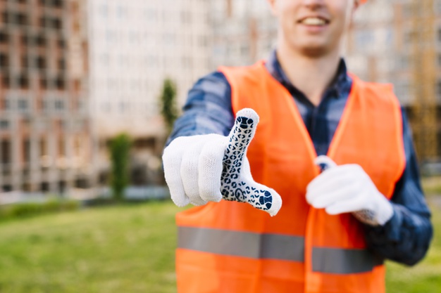 close-up-smiley-man-with-gloves-safety-vest_23-2148269366